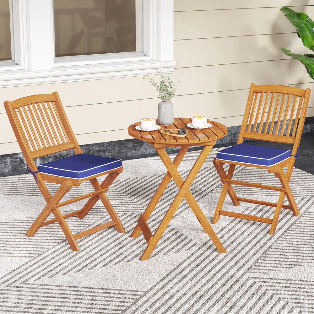 Set of 2 outdoor folding chairs with navy seat cushions, crafted from acacia wood for picnic or dining use.