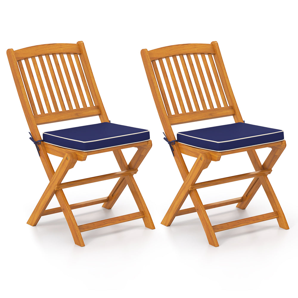 Set of 2 outdoor folding chairs made of acacia wood with navy seat cushions, ideal for dining and camping.