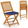 Set of 2 outdoor folding chairs in acacia wood with navy seat cushions, ideal for picnics and camping.