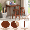 3-piece espresso bar table set featuring a wide MDF tabletop and two saddle stools, perfect for small spaces.