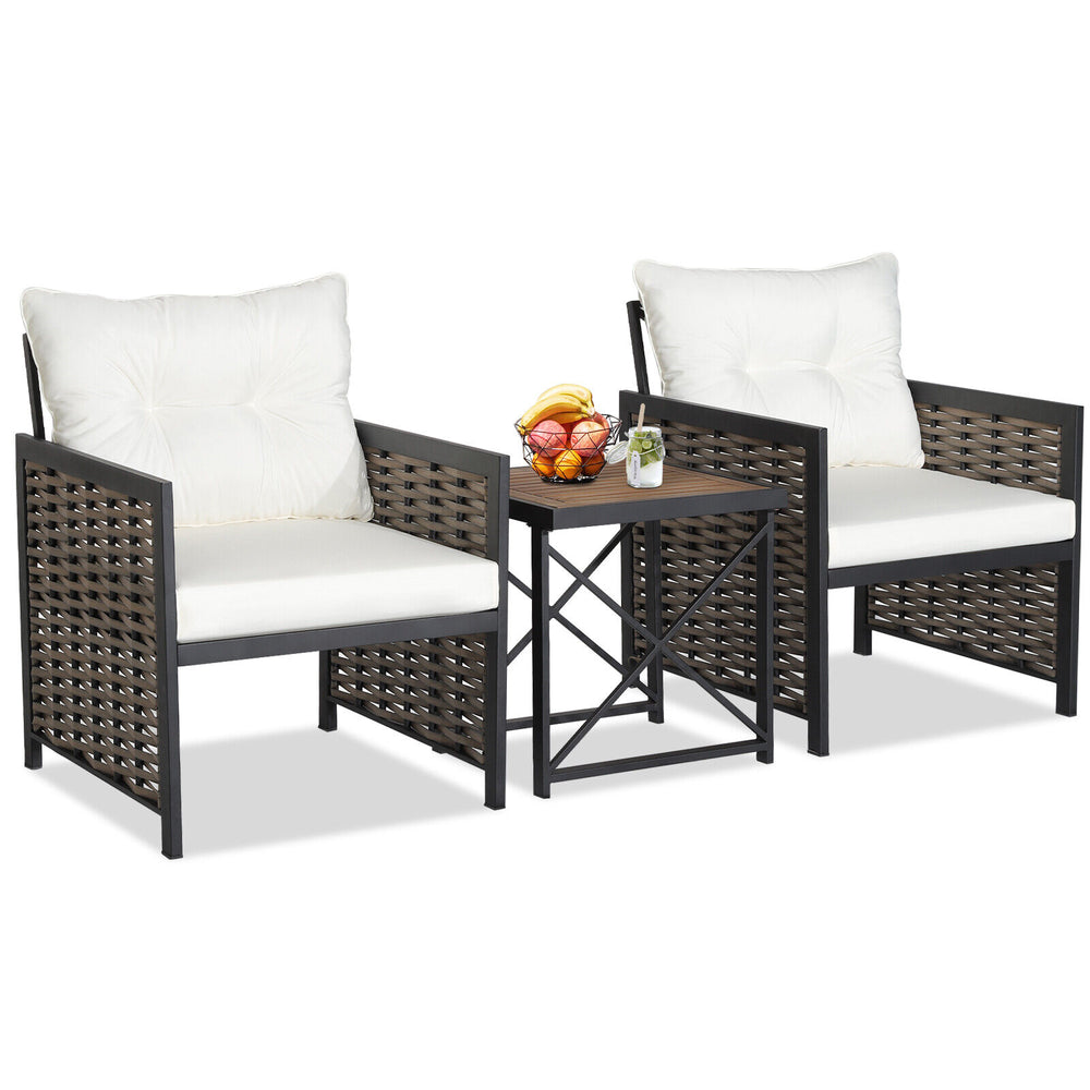 Two comfortable patio chairs with white cushions and a stylish acacia wood tabletop, perfect for outdoor relaxation.