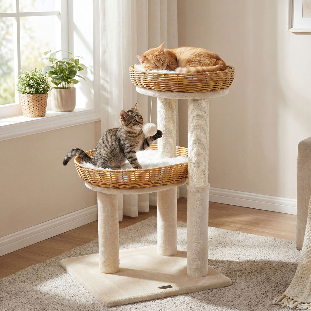 Two cats lounging in hand-woven rattan baskets on a 30-inch beige cat tower with sisal scratching posts.