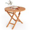Round 31.5-inch folding coffee table made of teak wood, featuring an X-shaped structure, perfect for outdoor dining.