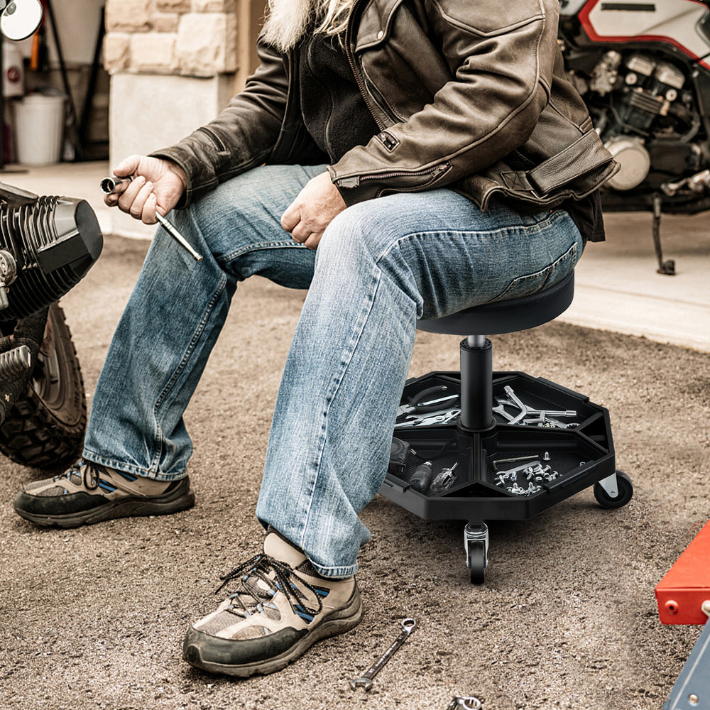 Pneumatic rolling mechanic stool with padded seat, 330 lbs capacity, and large tool tray for convenient access.