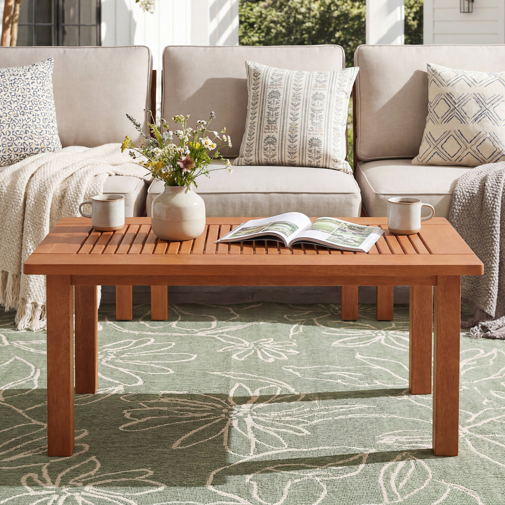 Rectangular hardwood coffee table with slatted top, perfect for outdoor use in backyard settings.