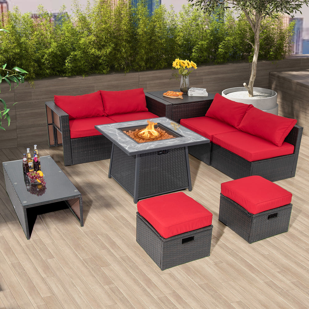 Outdoor propane fire pit table with black wicker rattan, red cushions, and lava rocks, perfect for backyard gatherings.