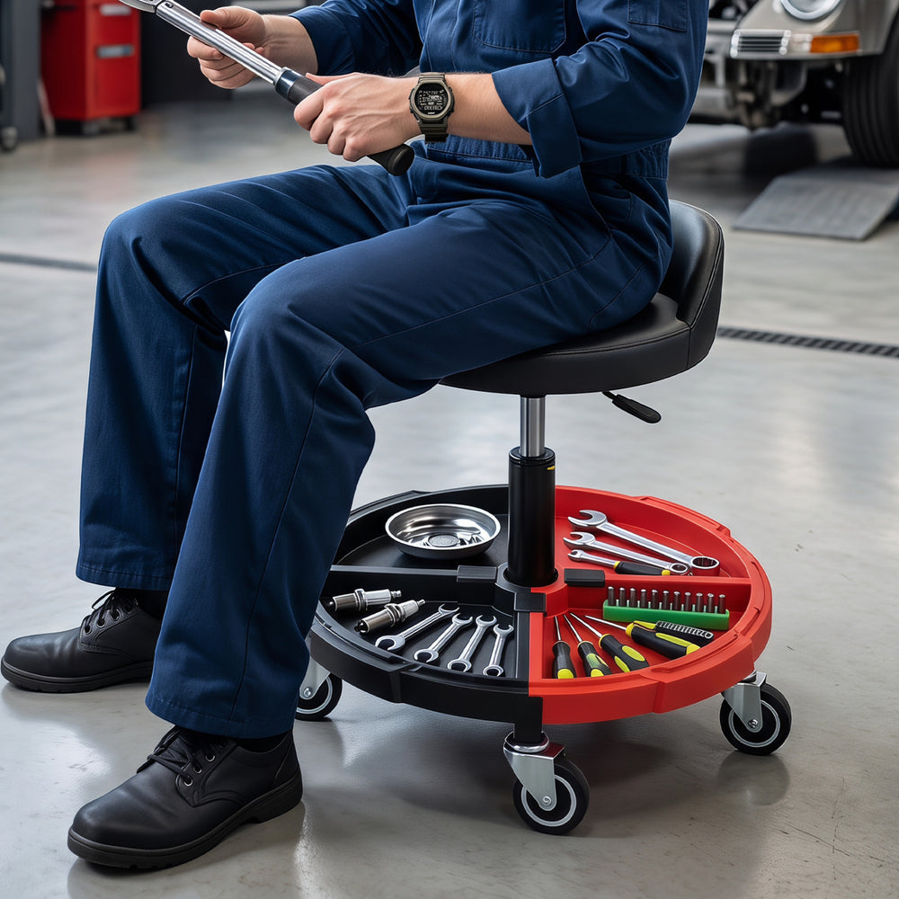 Mechanic stool with a padded seat and adjustable height, featuring a red tool storage tray for easy organization.