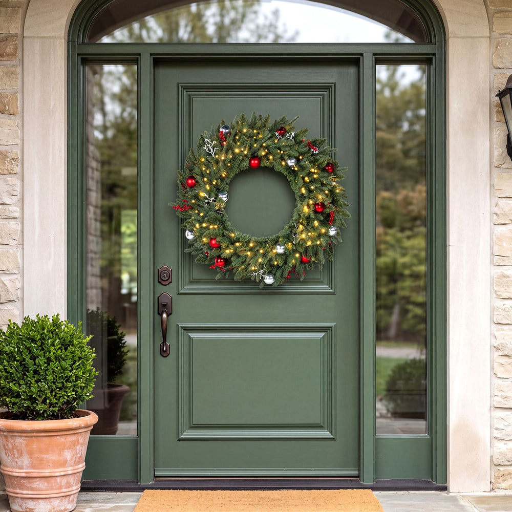 36-inch pre-lit Christmas wreath with red berries, ornaments, and warm white LED lights for festive front door decoration.