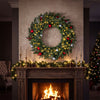 36-inch pre-lit Christmas wreath with red berries and ornaments, featuring 100 warm white LED lights for festive decoration.