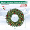 36-inch pre-lit Christmas wreath featuring 100 warm white LED lights, red berries, and a stable metal frame for festive decor.