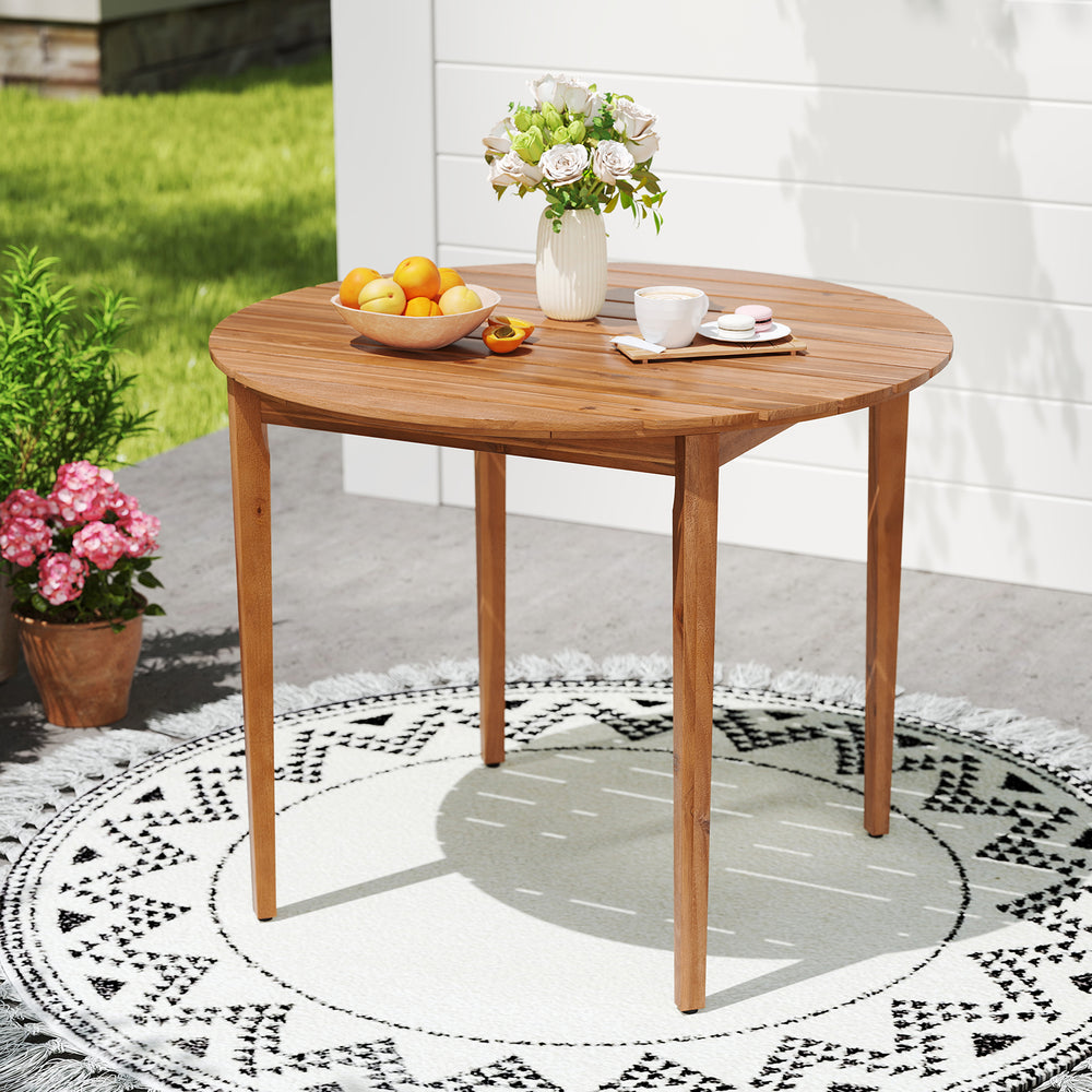 Round 36-inch acacia wood outdoor dining table for 4, featuring slatted design and smooth corners, ideal for patio use.