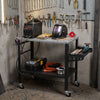 Welding table with lockable wheels, double-layer storage, and 144 fixture holes for efficient workspace organization.