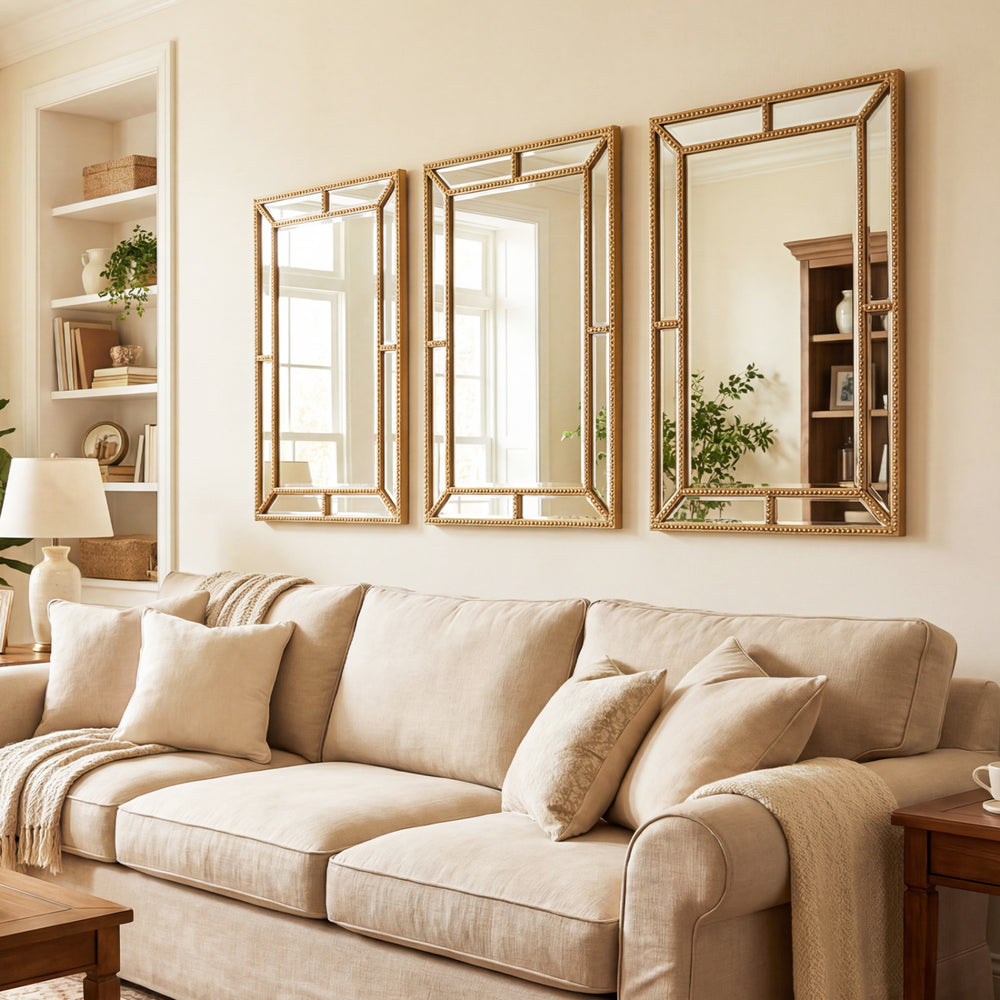 Gold wall mirror with beaded frame, 36 x 24 inches, adds timeless elegance to living rooms and entryways.