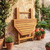 Folding octagonal acacia wood dining table for 4 with slatted tabletop, ideal for outdoor patios and gardens.