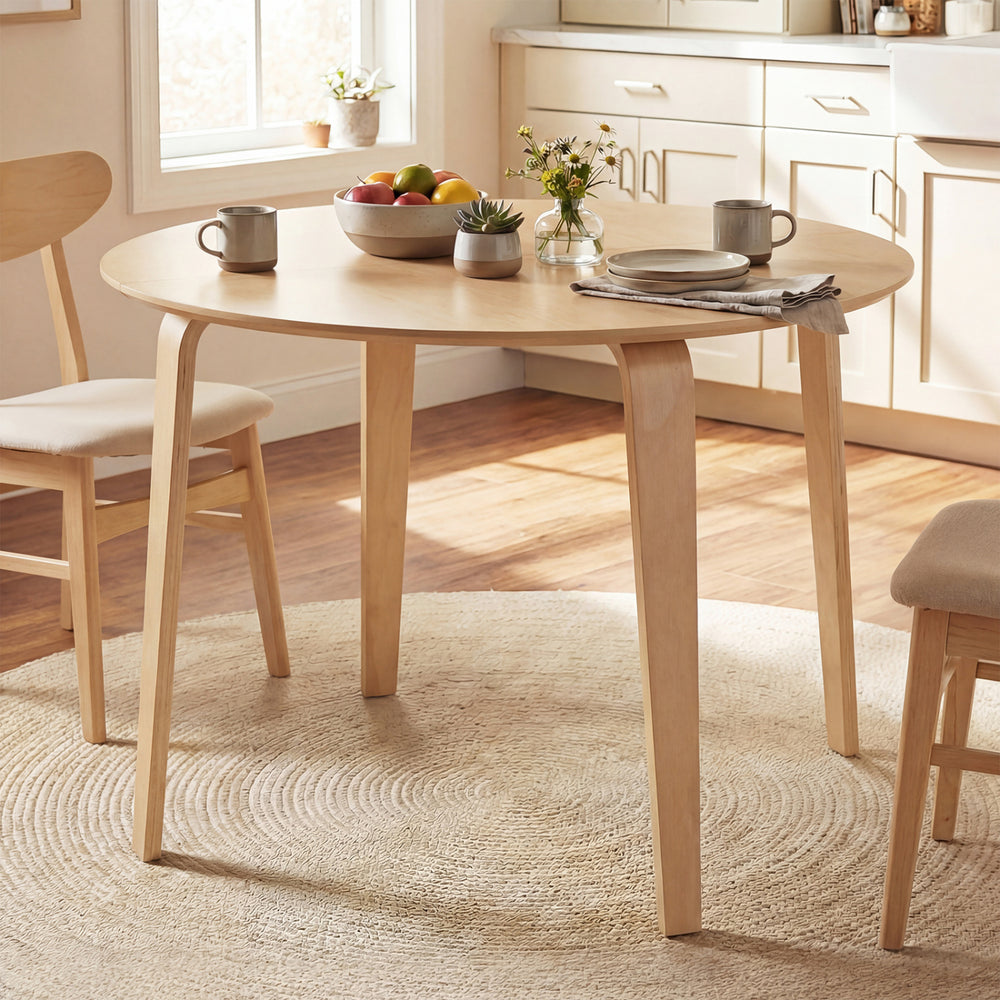 Round dining table with rubber wood legs, spacious for 4, perfect for small spaces in kitchens or dining rooms.