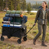 Heavy-duty collapsible wagon cart in black, carrying camping gear, with adjustable handle and all-terrain wheels for.