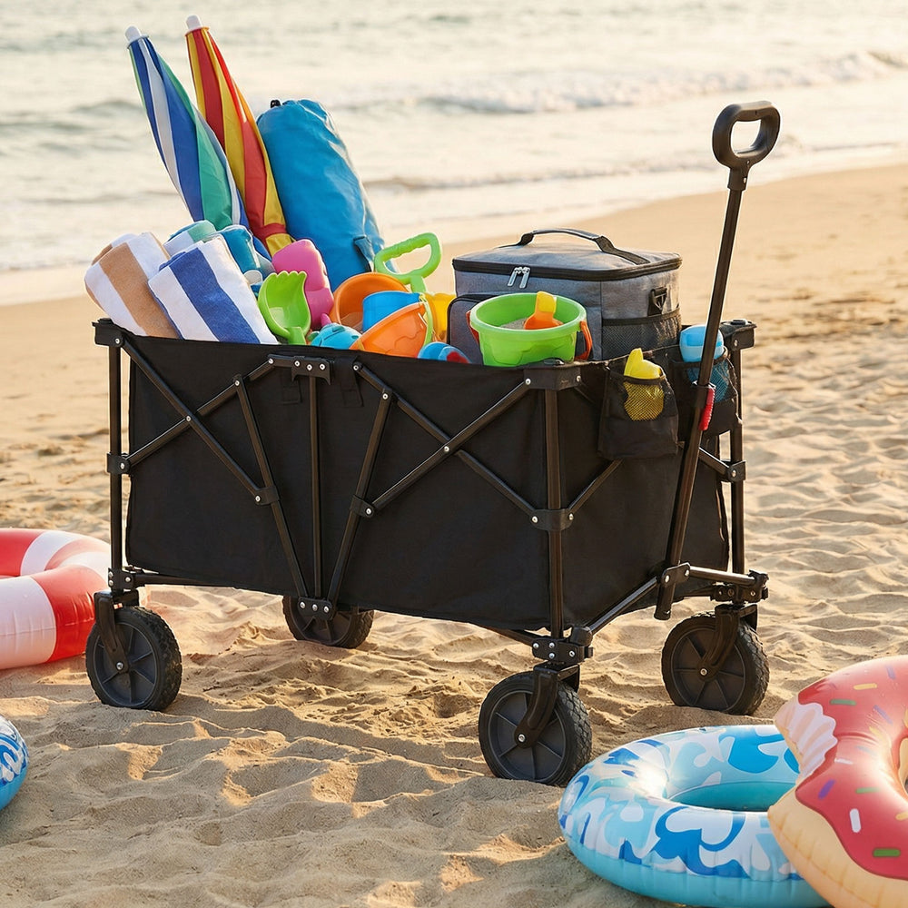 Heavy-duty collapsible wagon cart in black, filled with beach gear, ideal for camping and outdoor activities.