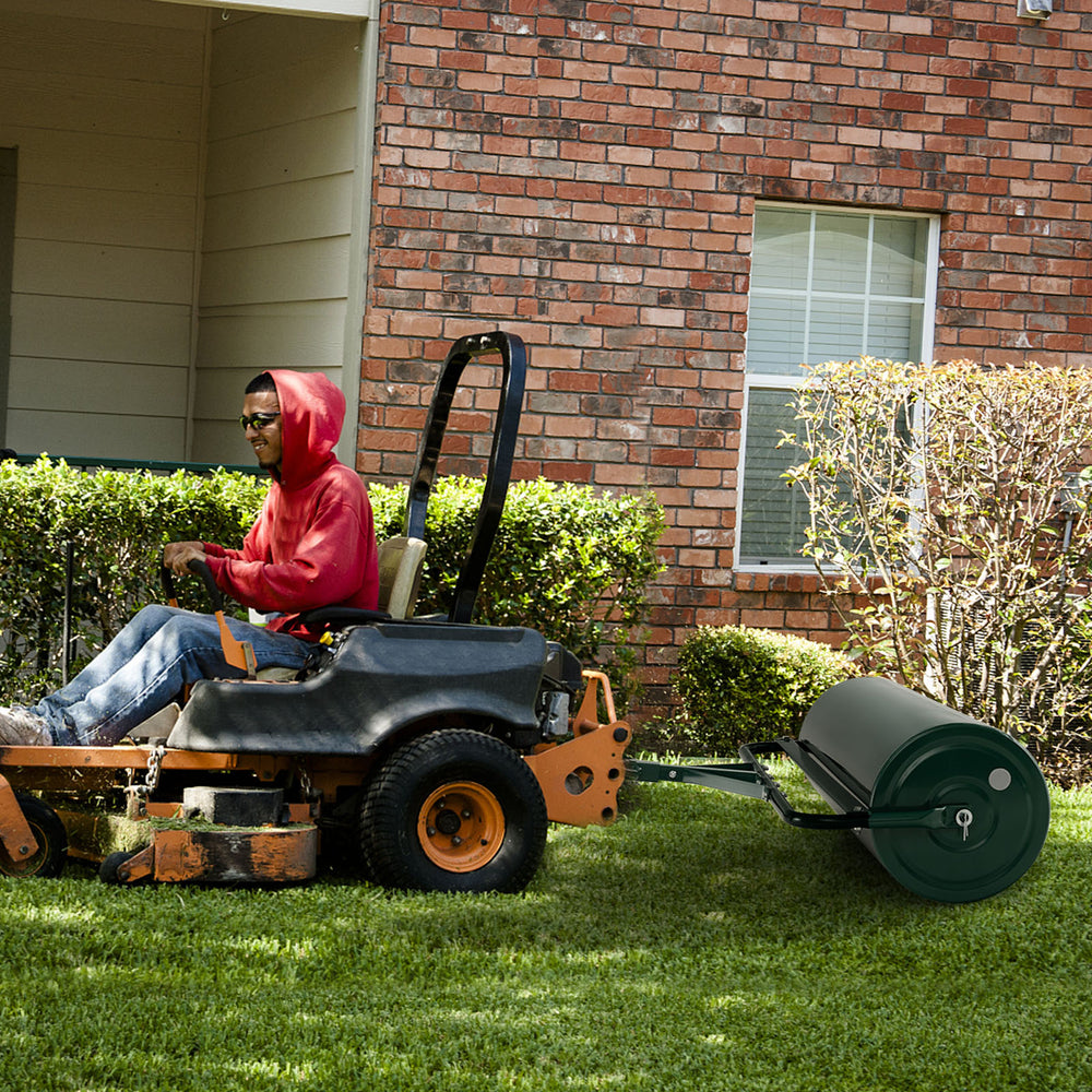 39-inch wide green lawn roller attached to a riding mower, ideal for leveling lawns and gardens with a 30-gallon.