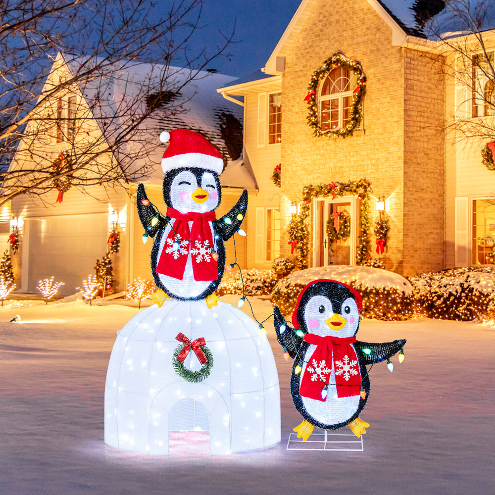 3D pre-lit holiday display featuring penguins and an igloo, decorated with LED lights for festive indoor or outdoor use.