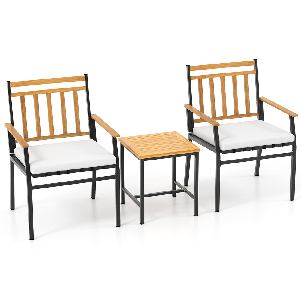 Two ergonomic chairs with acacia wood armrests and a matching table, featuring white cushions for outdoor patio use.