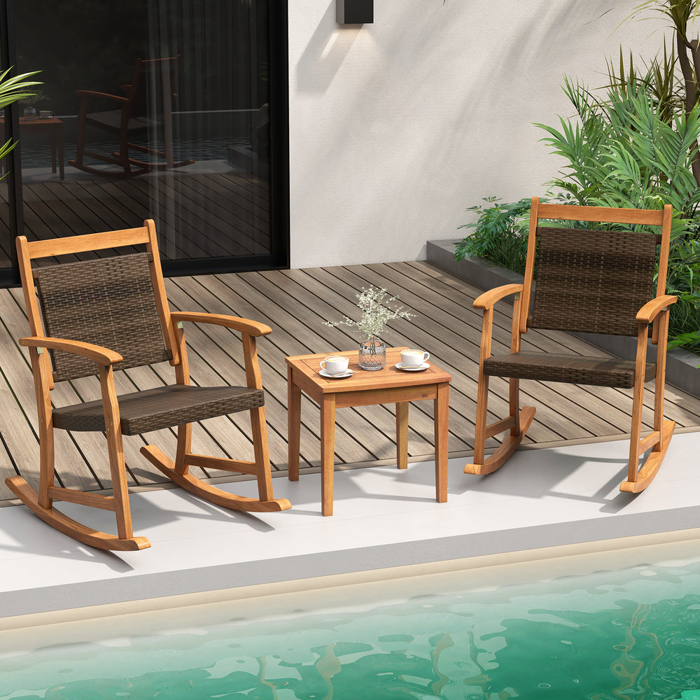 Acacia wood patio rocking chair set with side table, featuring weather-resistant wicker for outdoor relaxation.