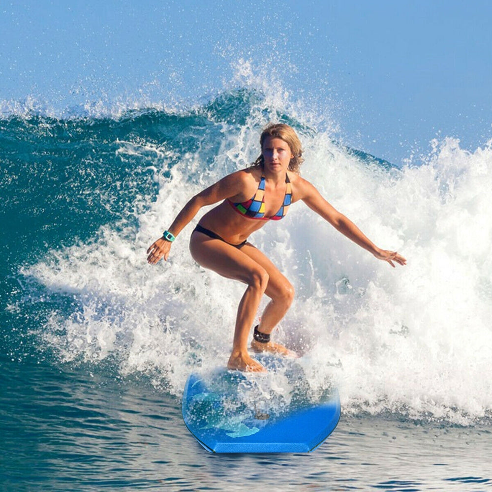 Surfer riding a wave on a blue lightweight bodyboard with EPS core, perfect for outdoor water sports.
