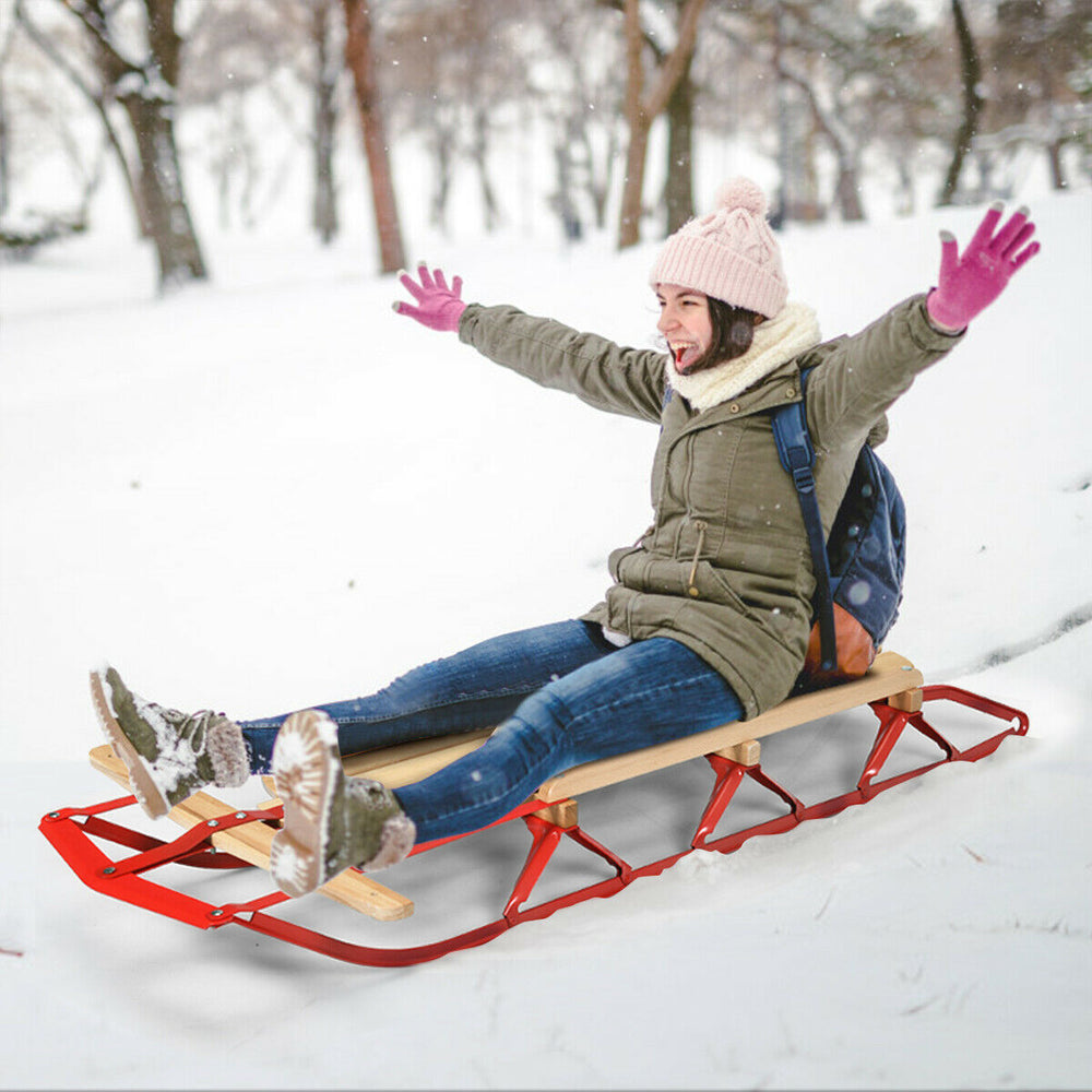 Kids wooden snow sled with metal runners and steering bar, designed for smooth sliding in the snow, suitable for ages 5.