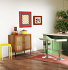 Adjustable bar stools and rattan storage sideboard in a modern kitchen setting, perfect for versatile dining solutions.