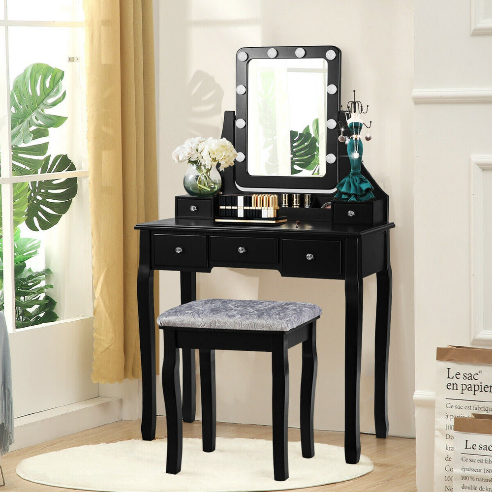Vanity dressing table set in black with 10 dimmable bulbs, cushioned stool, and 5 storage drawers for cosmetics.