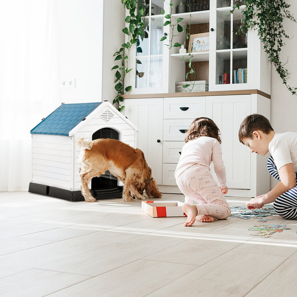 Durable plastic waterproof pet house with a blue roof, providing a cozy shelter for dogs indoors or outdoors.