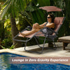 Folding recliner lounge chair with adjustable shade canopy and cup holder, perfect for outdoor relaxation by the pool.