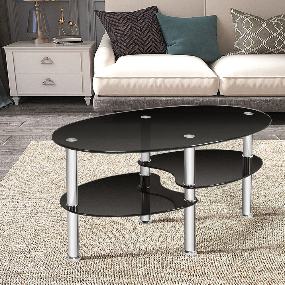Tempered glass oval coffee table with two bottom shelves, featuring a sleek black design for stylish living room decor.