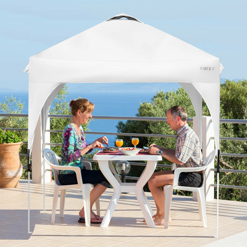 Pop-up height adjustable canopy tent in white, providing 6.6'x6.6' shade for outdoor dining and activities.