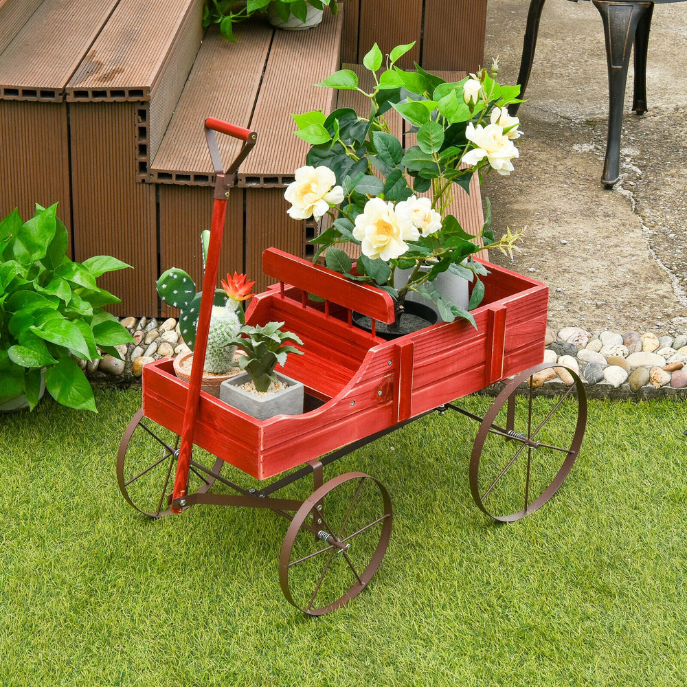 Red wooden wagon plant bed with wheels, featuring two planting sections, ideal for garden or patio decoration.