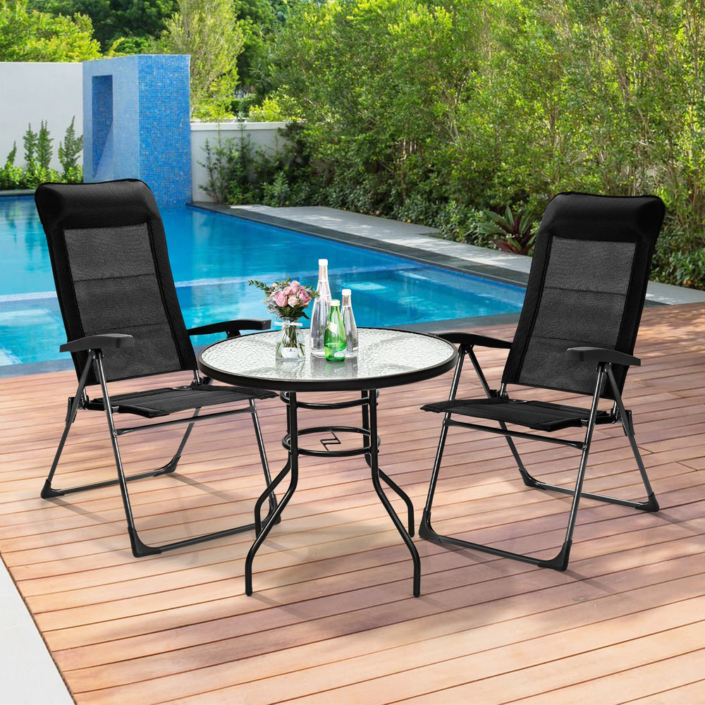 Two black portable patio folding dining chairs with adjustable headrests, perfect for outdoor relaxation by the pool.