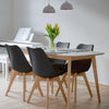 Set of 4 mid-century modern dining chairs with black PU seats and beech wood legs, perfect for kitchen gatherings.