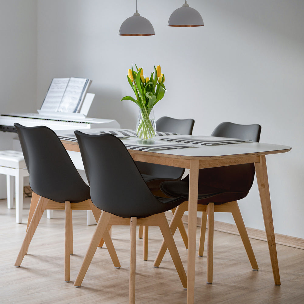 Set of 4 mid-century modern dining chairs with black PU seats and beech wood legs, perfect for kitchen gatherings.