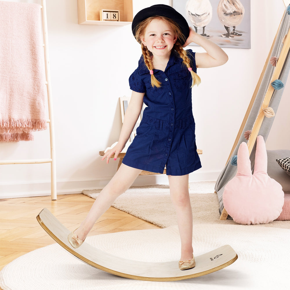 Child balancing on a 12-inch natural birch wobble board, promoting fun and coordination for indoor play.