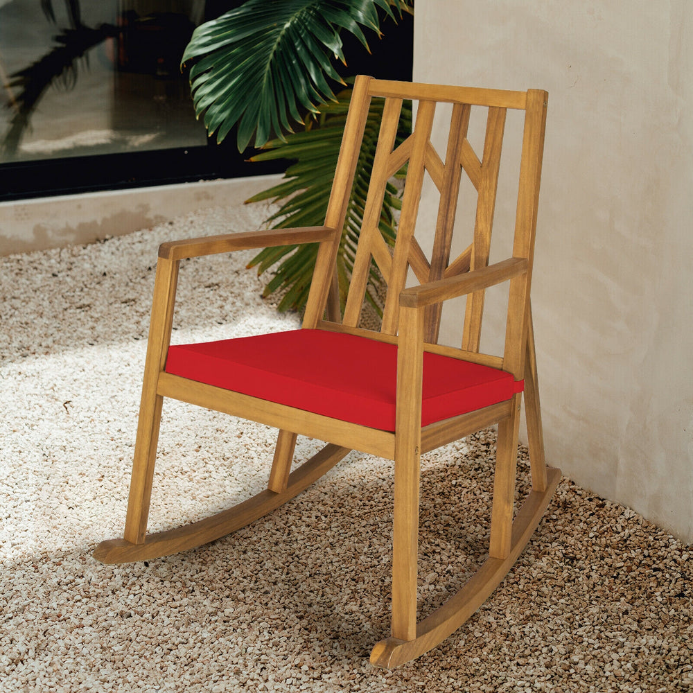 Acacia wood rocking chair with red cushion, featuring sturdy design and armrests, perfect for garden relaxation.