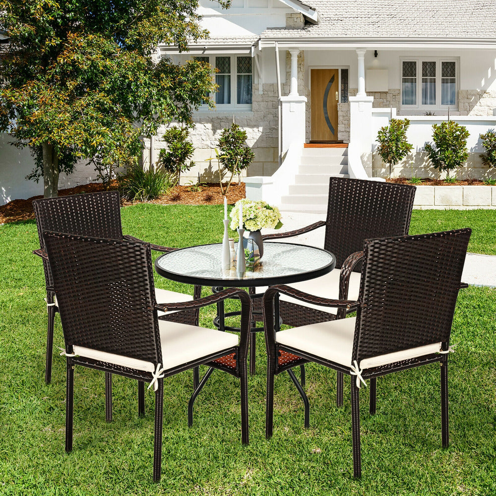 Set of 4 stackable patio rattan dining chairs with cushioned armrests, perfect for garden and outdoor use.
