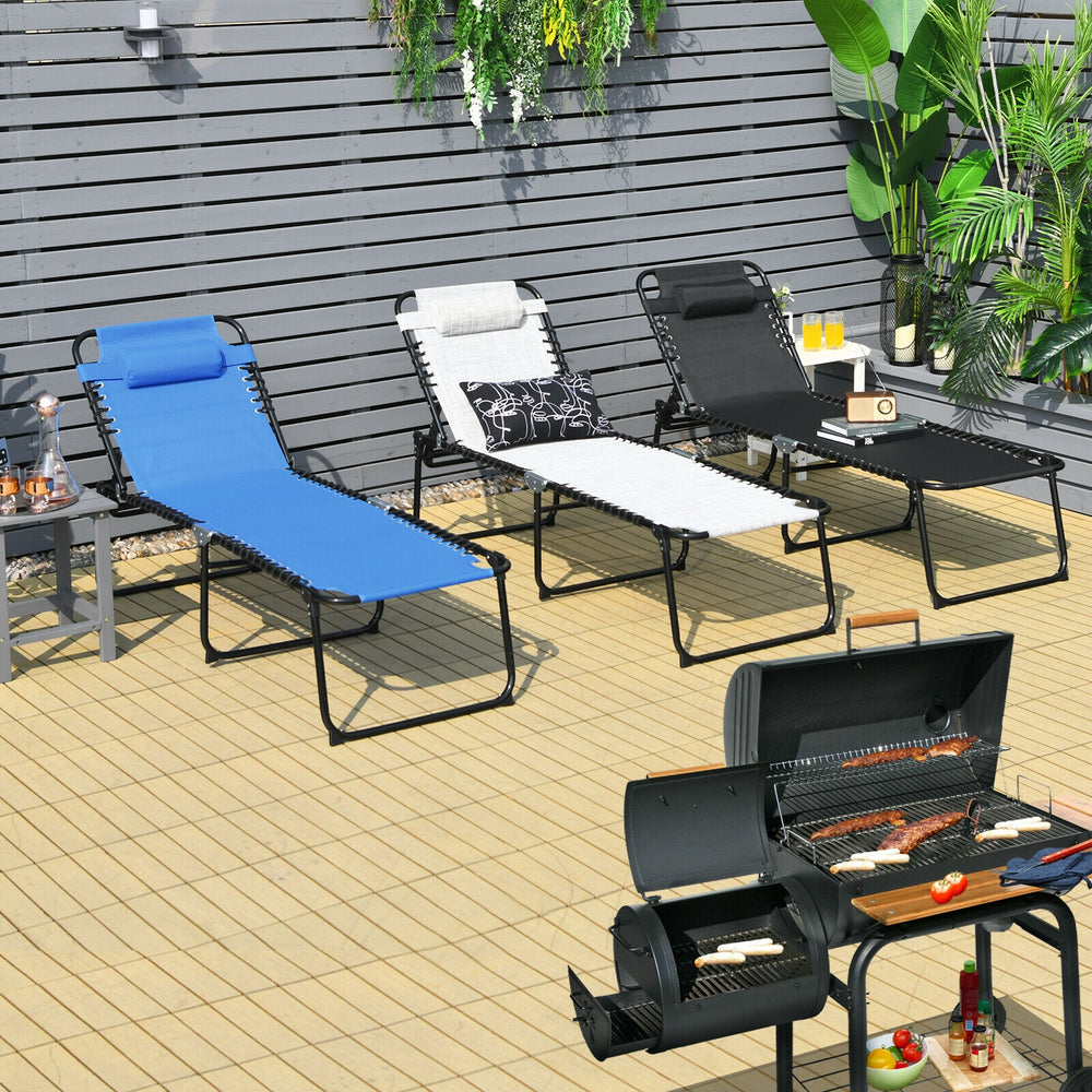 Foldable lounge chair in black with adjustable backrest and footrest, perfect for outdoor relaxation and stability.