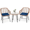 Two navy cushioned rattan armchairs and a glass-top side table, perfect for outdoor patio relaxation.