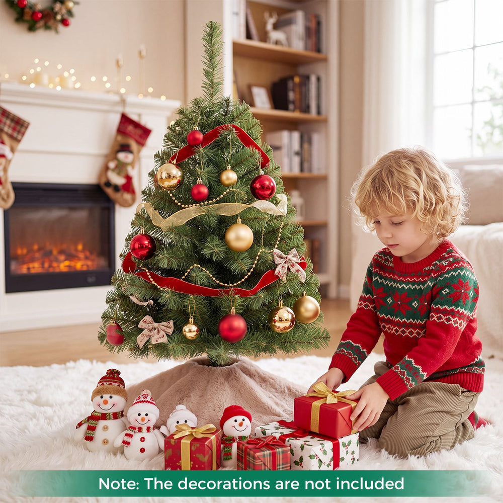 Decorated 3 FT Mini Tabletop Christmas Tree with 113 Green PVC Branch Tips beside holiday gifts indoors.