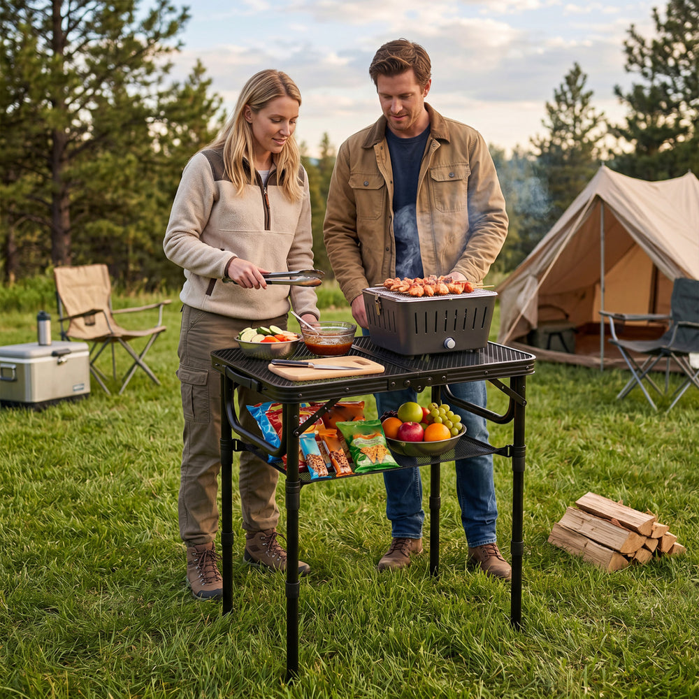 Folding camping table with adjustable height, aluminum build, and large storage net, perfect for outdoor grilling.
