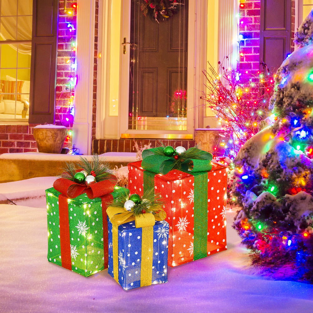 Vibrant Christmas lighted gift boxes with exquisite bows, creating a festive atmosphere for outdoor holiday displays.