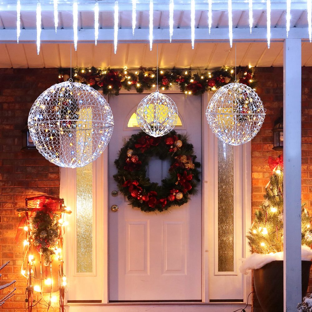 Large lighted Christmas balls with 435 LEDs, hanging on a porch for festive outdoor decoration during winter.