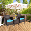 Two blue-cushioned rattan chairs and a glass-top table in a patio setting, perfect for outdoor relaxation.