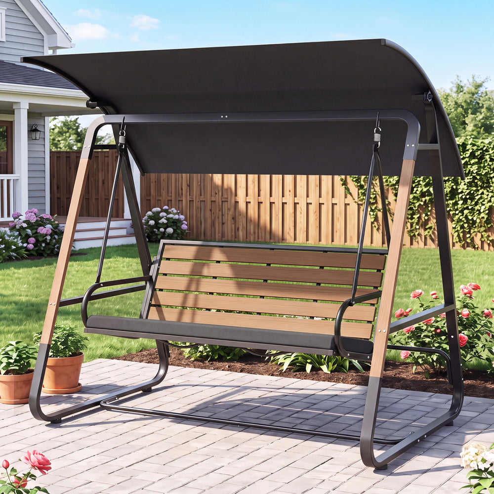 Three-person outdoor swing with adjustable black canopy, slatted back, and removable cushion for versatile backyard lounging.
