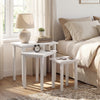 Three-piece white farmhouse side table set with sleek surfaces, perfect for living room use or as plant stands.