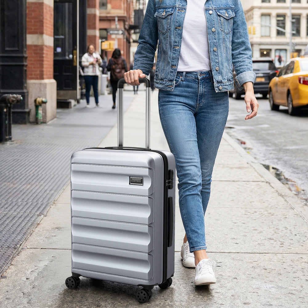Lightweight gray 20-inch hardside suitcase with 360° spinner wheels, ideal for effortless travel and storage.